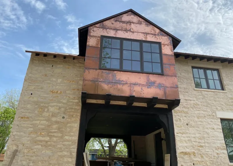 Copper metal panel facade on a stone building for Roof Repair in Adairsville